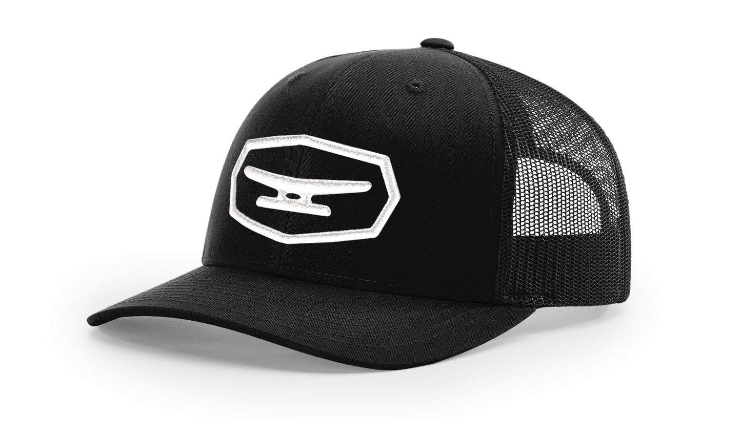Black Klēt trucker cap with puff embroidered patch and mesh back panel