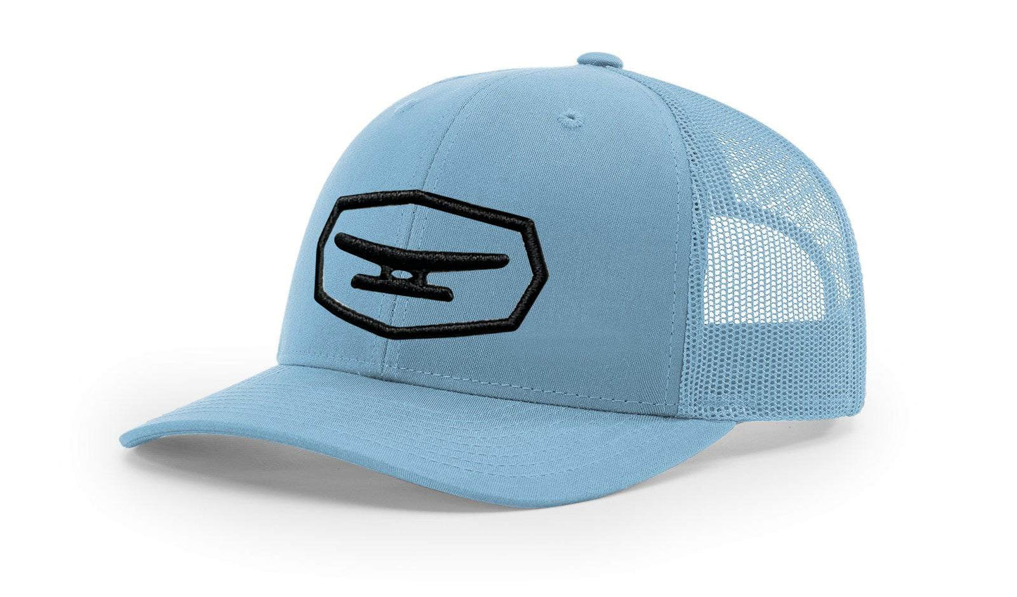 Light blue mesh trucker cap with black puff embroidered Klēt patch on front panel