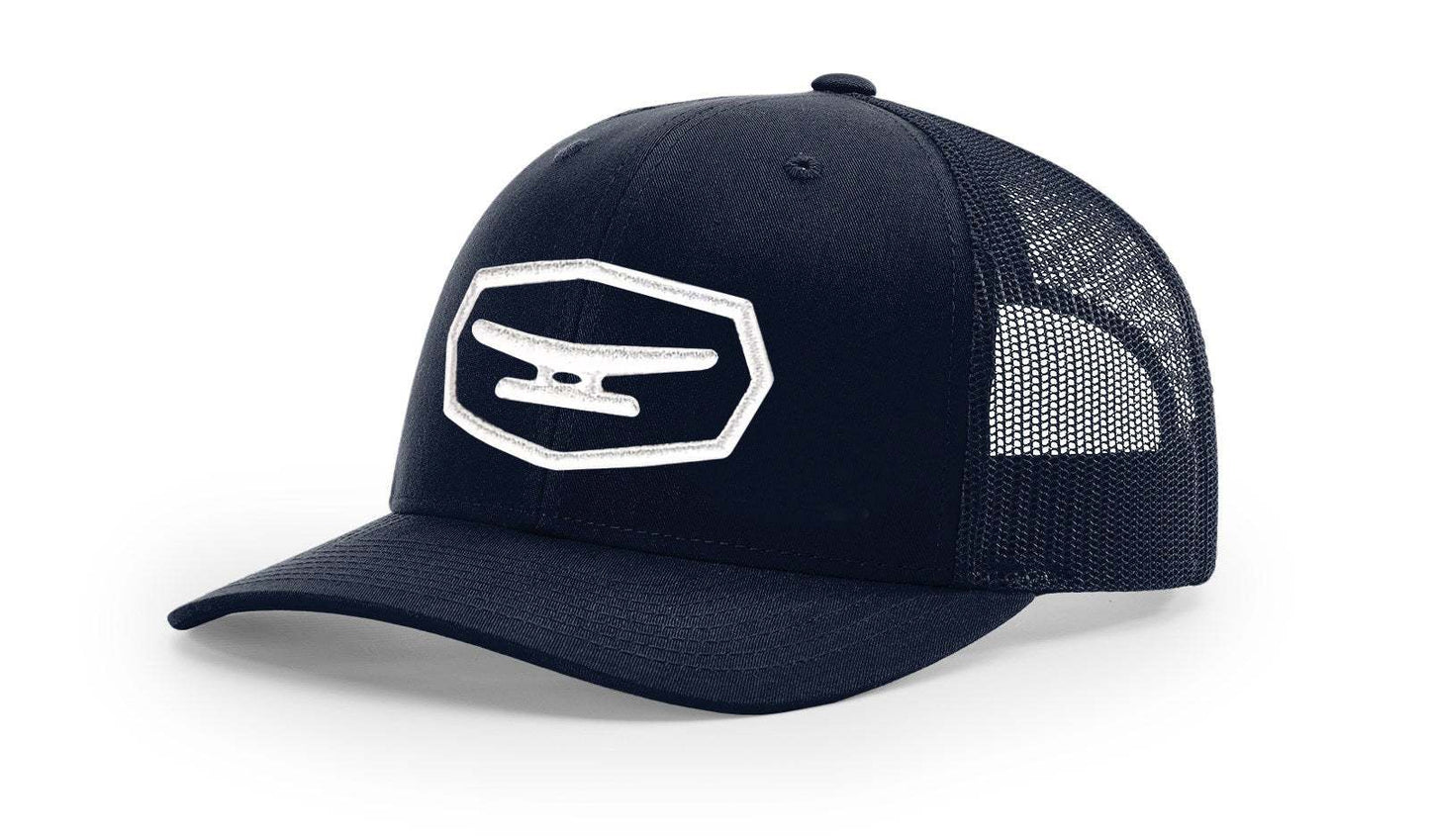Black mesh trucker cap with white puff embroidered Klēt patch logo on front