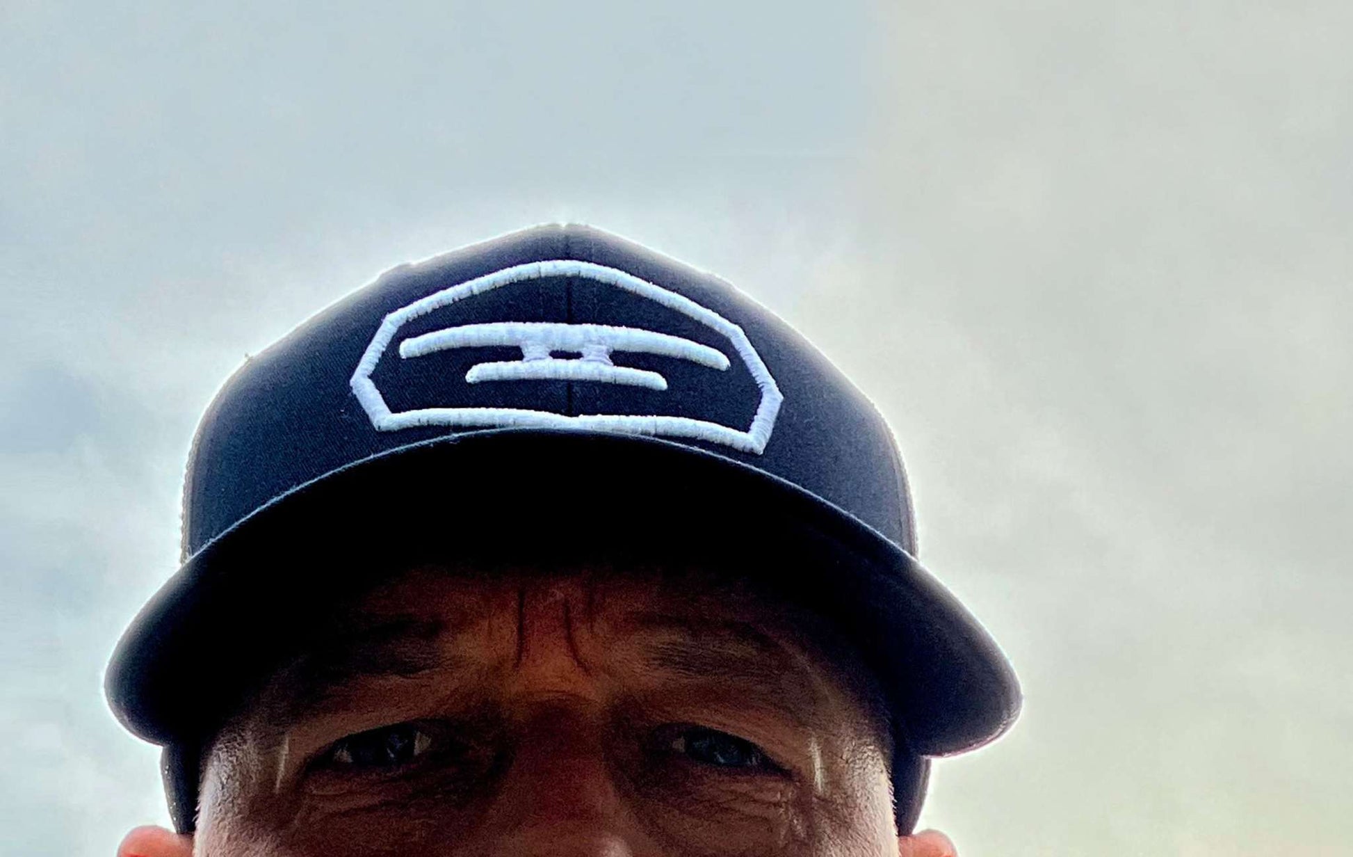 Navy blue cap with Klēt puff embroidered patch logo on front